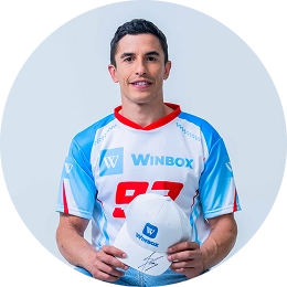 Marc Marquez wearing a Winbox jersey and holding a Winbox cap, as the Winbox Brand Ambassador.